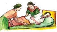 A caregiver and health professional changing the body position of a bedridden patient.