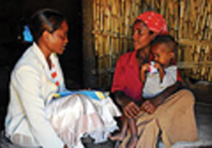 A health professional counselling a mother on feeding her child.