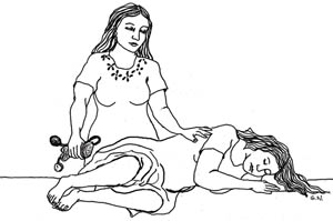 A health professional helps a pregnant woman turn onto her side ready to be transported to the hospital.