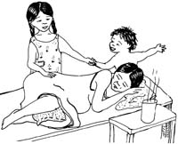 A pregnant woman lies on her side on a bed. She has a pillow between her knees. Beside her is a hot drink. On the other side of the bed is her other two children. The smaller of the two is pulling the older one away to play.