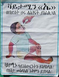 A poster message with a baby on the front. The baby is receiving some medicine.