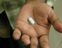 A hand with a ARV drug placed in the palm.